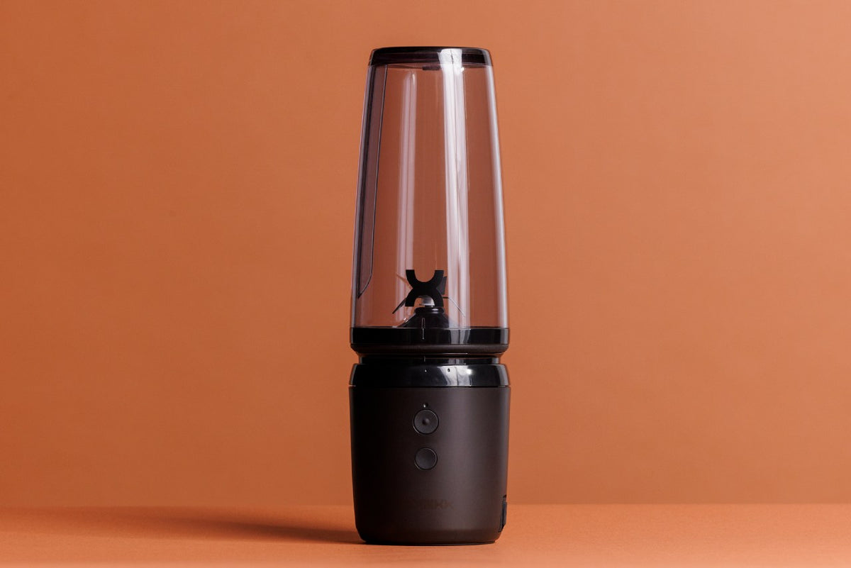 A modern lamp with a transparent top on an orange background.