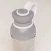 PROMIXX Ecozen Hybrid water bottle in Graphite Gray, translucent BPA-free Ecozen body, upper section with the flip spout open and the perforated mixing dome seated in the neck.
